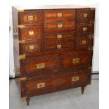 A mid 20th century Kashmiri hardwood carved campaign style brass inlaid double chest of drawers,
