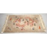 A Chinese rectangular Superwash wool rug, cream ground decorated with mythical dragon, 190 x 80cm.