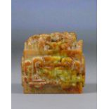 A Chinese carved jade russet included square sectioned seal with stylised dragon to the upper