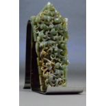 A Chinese carved spinach jade and russet included plaque of tapering rectangular form with raised