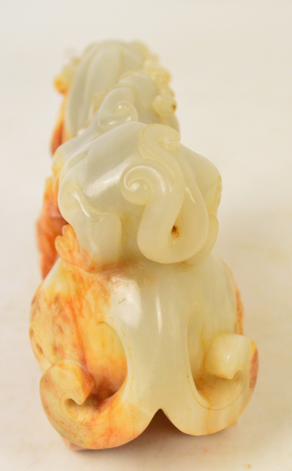 A Chinese pale celadon and russet included carved jade model of a dragon with small dragon upon the - Image 5 of 5