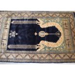 An Oriental wool rug, dark blue ground with temple door design, 160 x 94cm.