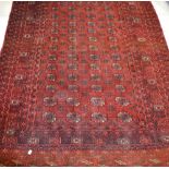 An antique Pakistani red ground rug with medallion and geometric design, 174 x 130cm.