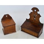 A George III oak candle box with shaped back and sloping hinged cover,