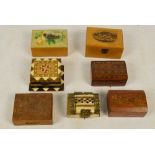 A small collection of small treen boxes including a Mauchlineware box decorated with a scene of