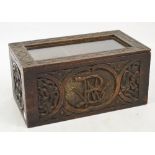 A late Victorian oak rectangular box with glazed hinged lid and front carved with initials BW,