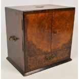 A Victorian walnut smokers' cabinet with two integral drawers, lower drawer and brass handles,