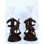 A near pair of late 19th century Black Forest carved beech opposing single epergne stands,