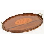 An Edwardian mahogany galleried twin handle tea tray centred with a large satinwood conch shell