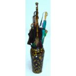 A collection of vintage umbrellas in a baluster shaped umbrella stand,