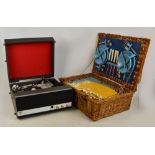 A wicker picnic hamper by Brexton containing cutlery and flatware, plates, knives and forks,