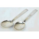 A pair of Arts and Crafts George VI hallmarked silver part hammered serving spoons with oval bowls