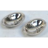 GEORG JENSEN; a pair of silver oval salts in the "Blossom" pattern, also known as "Magnolie" (no.