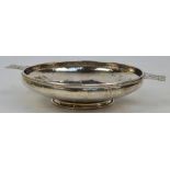 ALBERT EDWARD JONES; a George V hallmarked silver twin handled shallow bowl "Aesop's Fables",