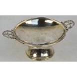 ALBERT EDWARD JONES; an Arts and Crafts George V hallmarked silver twin handled pedestal bowl,