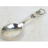 CARL M COHR; a Danish silver caddy spoon with pierced foliate decorated handle and rounded bowl,