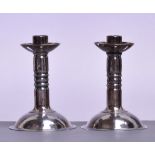 GEORGE HUNT; a pair of hammered silvered candlesticks,