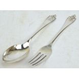 GEORG JENSEN; a hallmarked silver christening spoon and fork in the "Akkeleje" pattern,