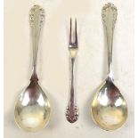 GEORG JENSEN; two silver spoons and a silver pickle fork in the "Rose" pattern,