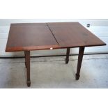 An Edwardian fold over card table on tapering legs and shaped feet, length when extended 120cm.