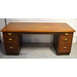 An early 20th century oak twin pedestal office desk,