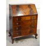 A reproduction flame mahogany bureau, fitted interior above four drawers and cabriole legs,