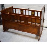 A vintage wooden child's cot decorated with animal scenes, length 120cm.