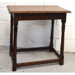 An Ercol rectory style oak side table on turned legs and stretchers, length 69cm.