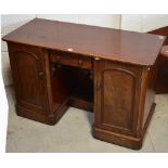 A mahogany twin pedestal desk on moulded plinth base, width 122cm.