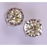 A pair of 18ct white gold diamond set ear studs, each diamond weighing approx 0.