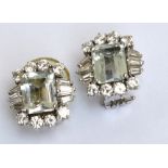 A pair of white metal Art Deco designed diamond and pale green stone set earrings,