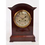 An Edwardian mahogany domed bracket clock, the circular silvered dial set with Arabic numerals,