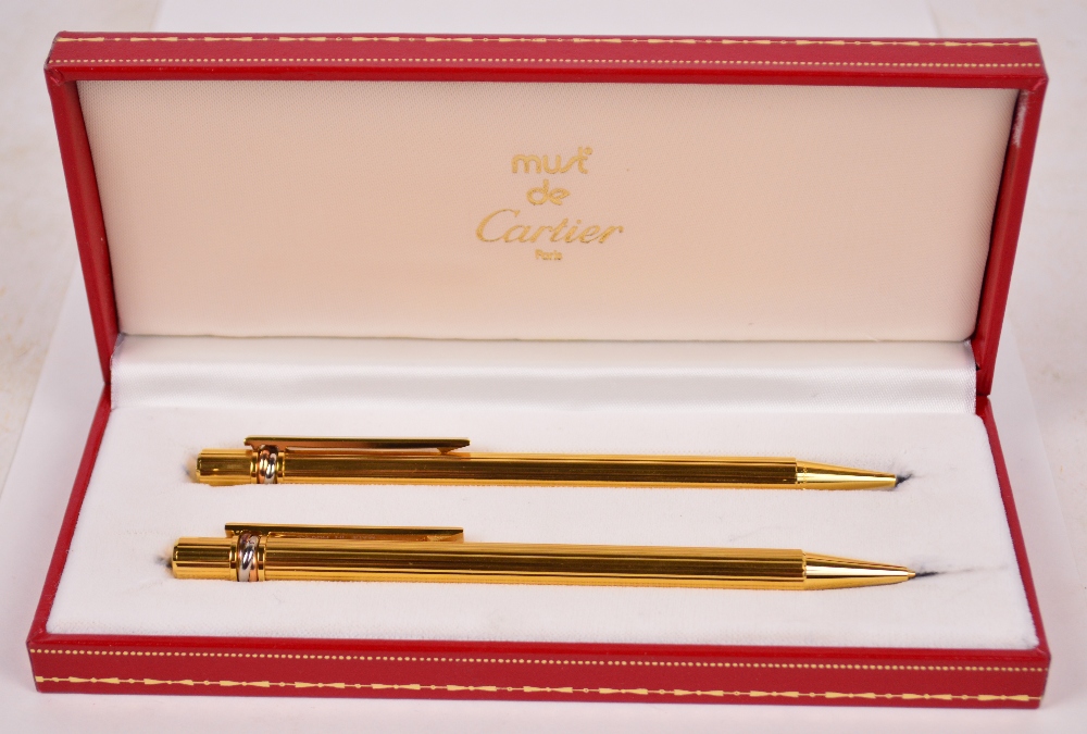 A boxed set of Must de Cartier ballpoint pen and propelling pencil,