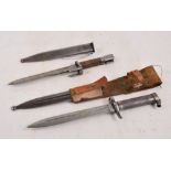 Two WWI period bayonets with metal scabbards, one with leather belt loop attachment.