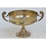 An early 20th century English hallmarked silver shallow footed bowl with twin scrolling handles,