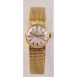 OMEGA; a 9ct yellow gold cased lady's wristwatch, the brushed dial set with baton numerals,