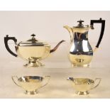 A George VI hallmarked silver three piece tea service with associated hot water jug,