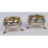 A pair of Victorian hallmarked silver open circular salts with floral embossed and engraved