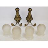 A pair of Art Nouveau brass two branch light fittings on shaped wooden shields, height 26cm,