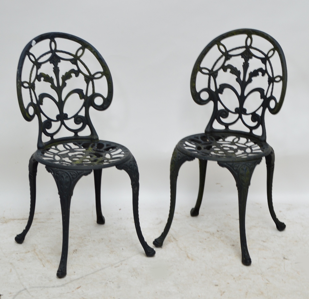 A pale blue bistro set comprising painted metal table and two folding chairs,