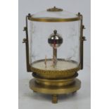 An unusual brass and glass Art Deco style fish bowl clock with central "Globe" set with painted