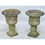 A pair of campana shaped urns with fluted bowls and rims decorated with fruit, height 67cm.