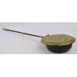 A 17th century Dutch brass and iron handled warming pan with domed pierced cover centred with a