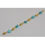 A yellow metal "nugget" and turquoise set bracelet, length 18.5cm.