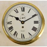 A large circular brass cased ship's clock,