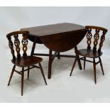 An Ercol dropleaf dining table raised on four outswept supports and a set of six Ercol dining