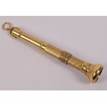 A 9ct gold cigarette piercer with part engine turned decoration and with suspension ring,