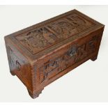 A 20th century camphor wood chest carved in relief with Chinese court scenes to each side,