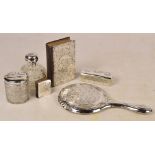 An Edwardian hallmarked silver covered clear cut glass dressing table jar of cylindrical form,