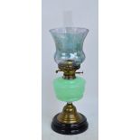 A Victorian brass mount oil lamp with green semi-opaque reservoir and lustre glazed flared shade,